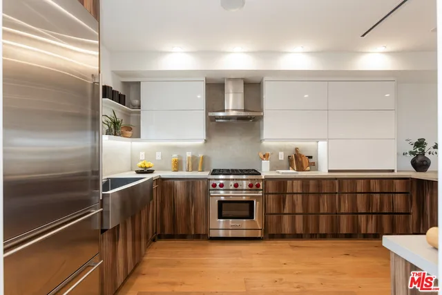 a kitchen with stainless steel appliances granite countertop a stove and a refrigerator