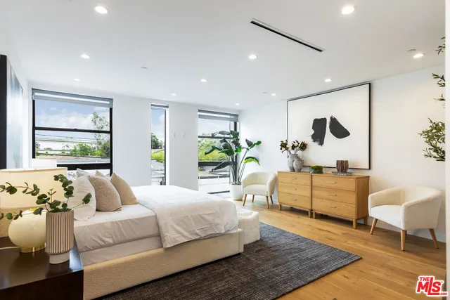 a spacious bedroom with a bed and a couch