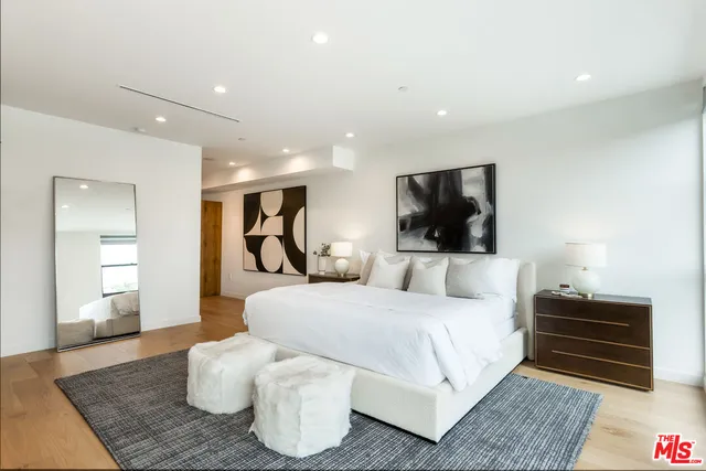 a bedroom with a bed and a couch