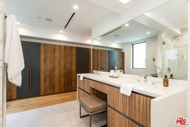 a bathroom with a sink double vanity and a mirror