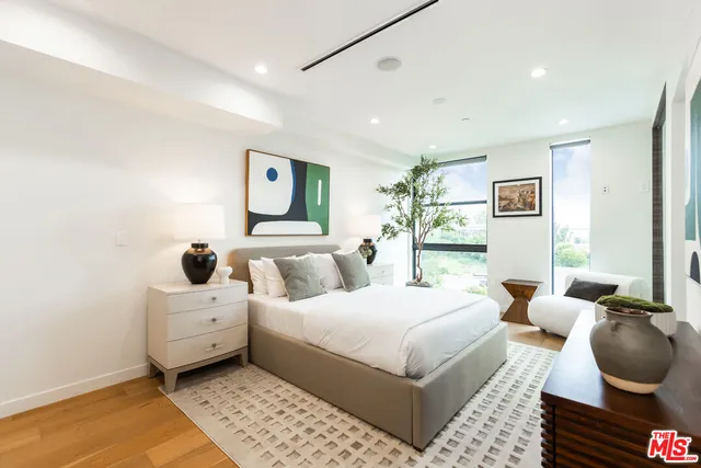 a room with a bed and glass door