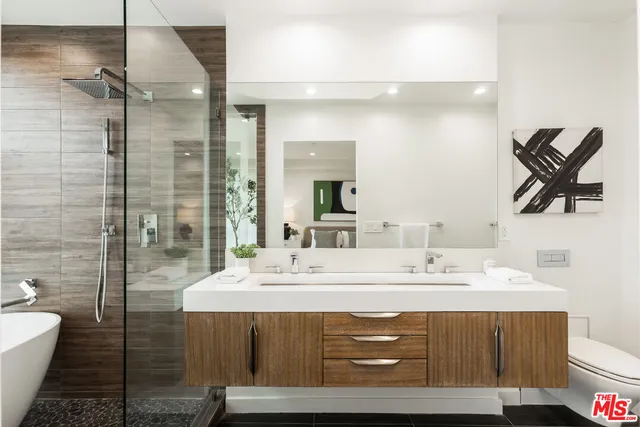 a bathroom with a double vanity sink mirror and shower