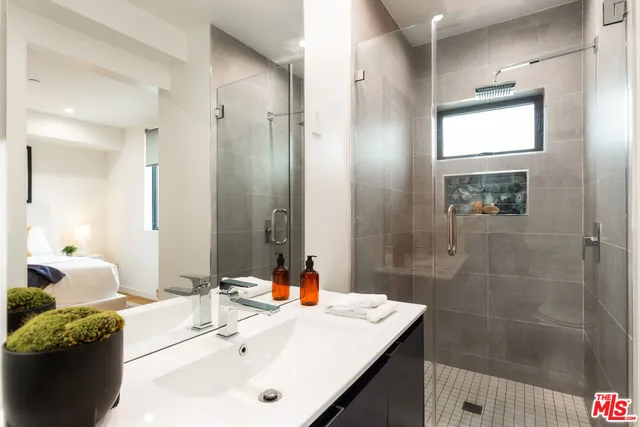a bathroom with a sink double vanity and a mirror