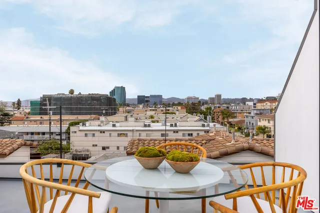 a outdoor dining space with furniture and city view
