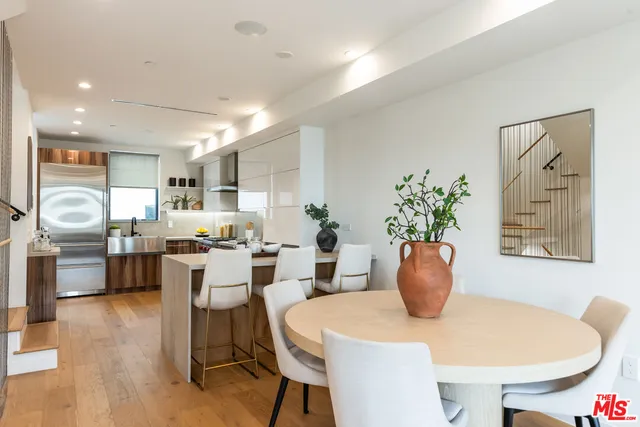 a dining room with furniture a window and wooden floor
