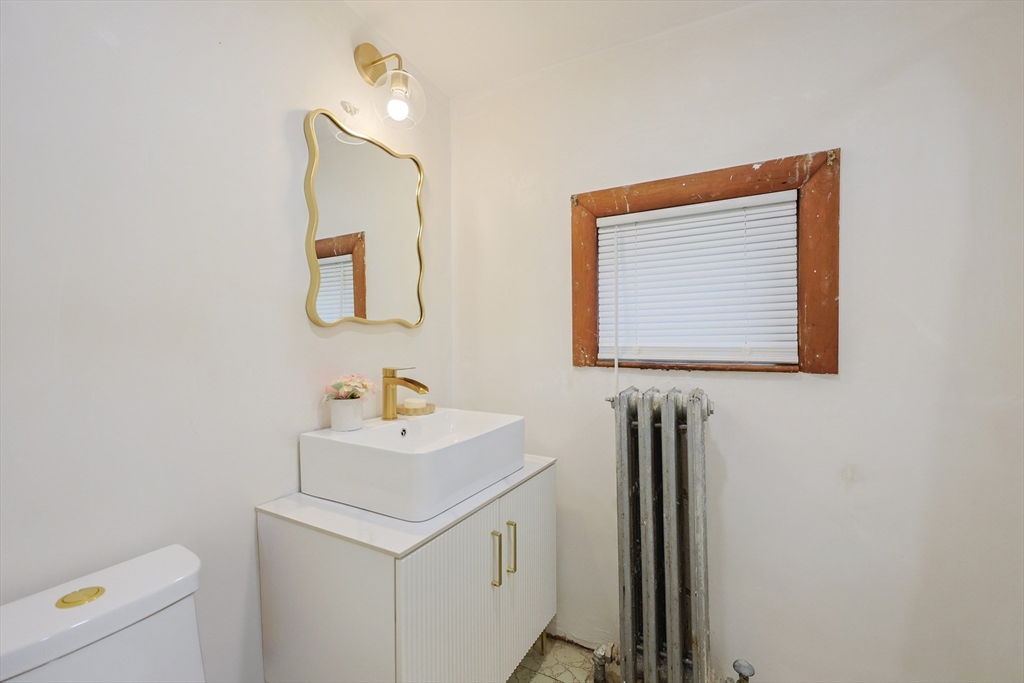 12 Lothrop Street Saugus, MA 01906 - Photo 11 of 42 a bathroom with a sink a vanity and a window