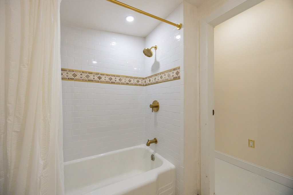 12 Lothrop Street Saugus, MA 01906 - Photo 12 of 42 a bathroom with a tub and a shower