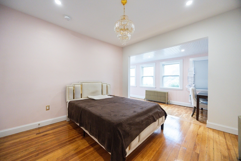 12 Lothrop Street Saugus, MA 01906 - Photo 13 of 42 a bedroom with a bed and a table in it