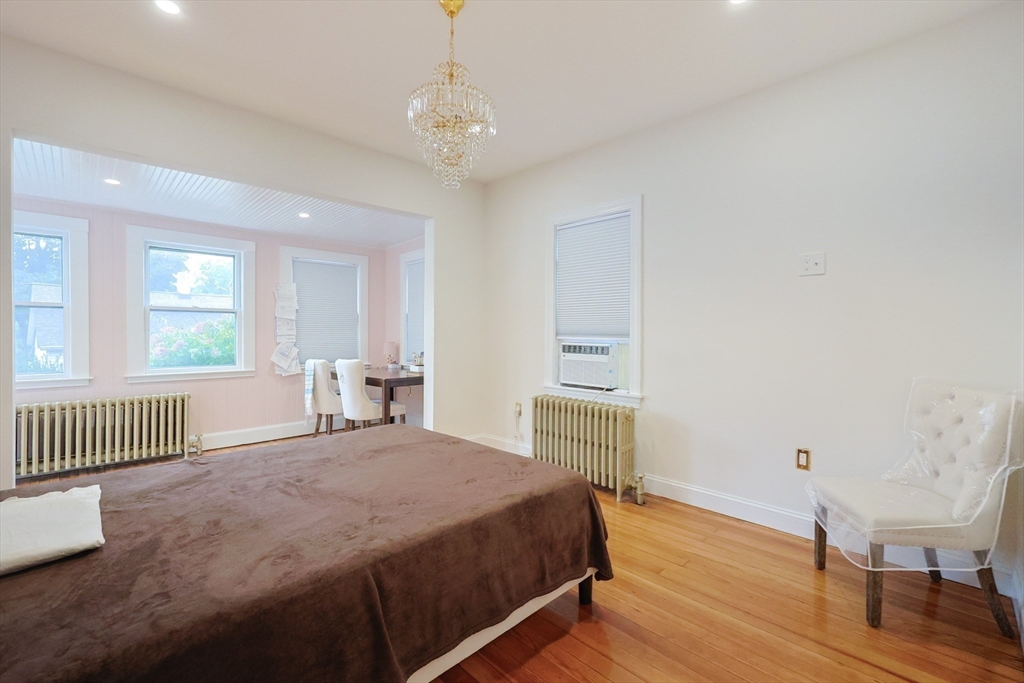 12 Lothrop Street Saugus, MA 01906 - Photo 14 of 42 a spacious bedroom with a bed and a window
