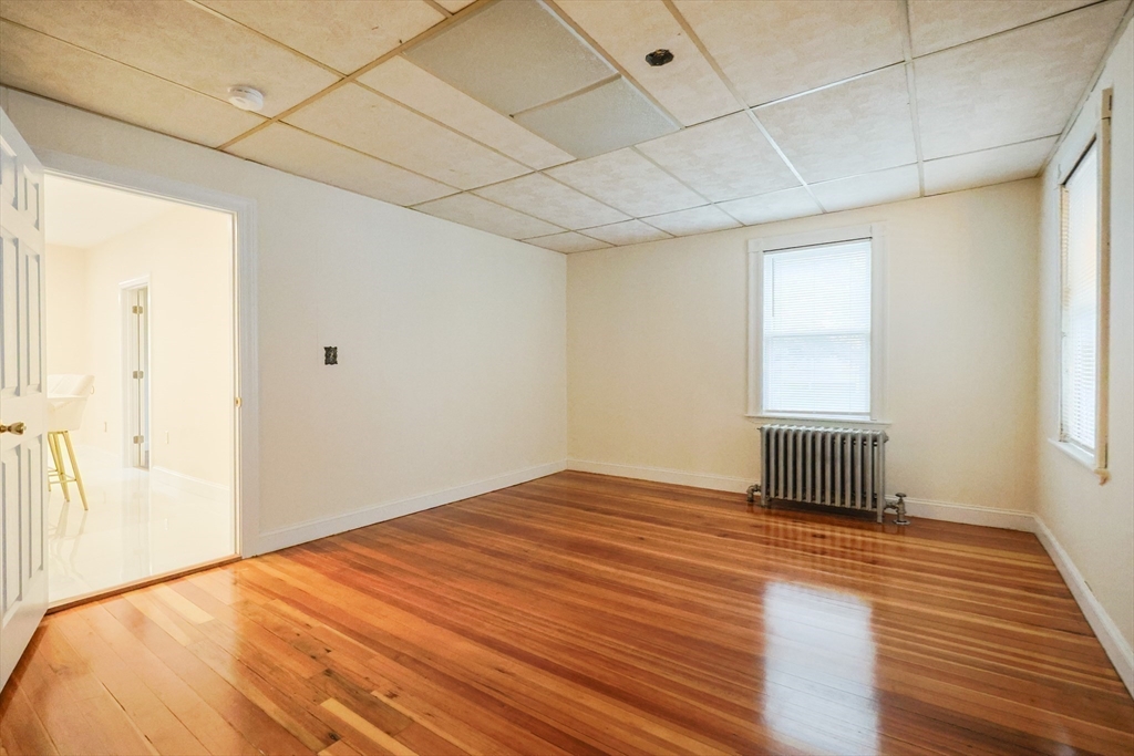 12 Lothrop Street Saugus, MA 01906 - Photo 19 of 42 a bedroom with a bed and a window