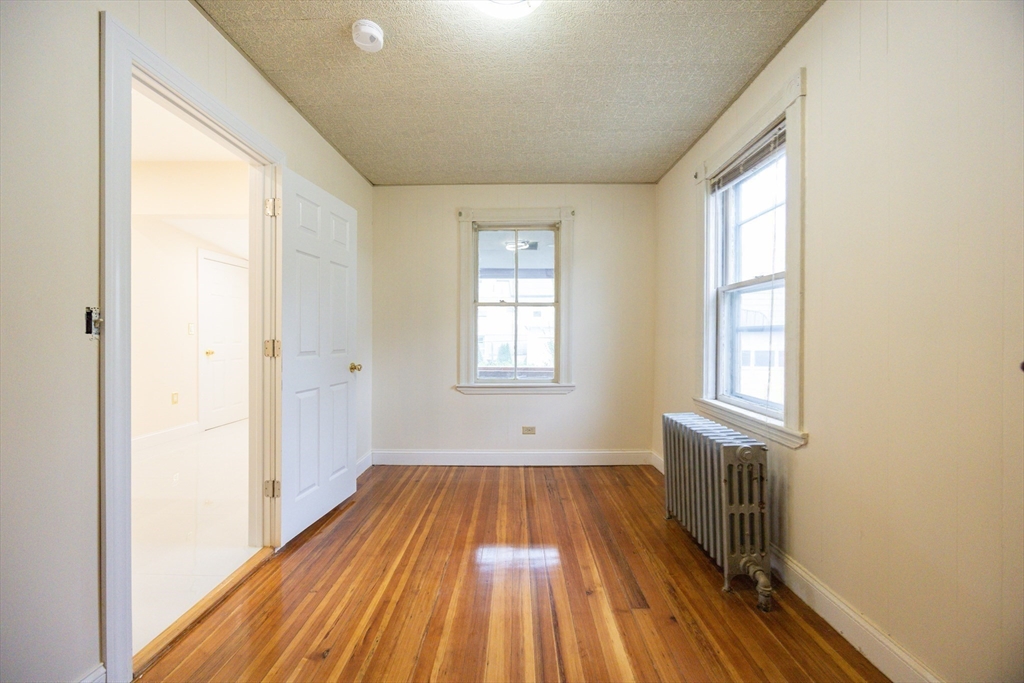 12 Lothrop Street Saugus, MA 01906 - Photo 22 of 42 a view of a room with wooden floor and windows