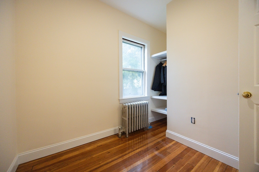 12 Lothrop Street Saugus, MA 01906 - Photo 23 of 42 a view of an empty room with wooden floor and a window