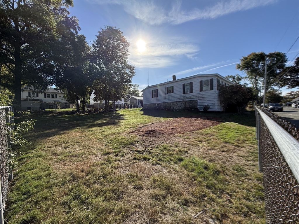 12 Lothrop Street Saugus, MA 01906 - Photo 28 of 42 a view of a yard with a house in the background
