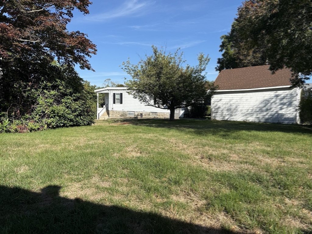 12 Lothrop Street Saugus, MA 01906 - Photo 31 of 42 a view of a yard with a house in the background