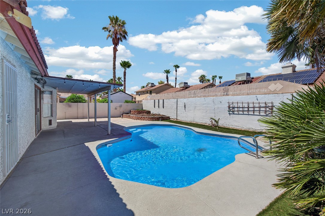 2609 Shakespeare Road Las Vegas, NV 89108 - Photo 35 of 41 An inviting backyard oasis offers a sparkling in-ground pool and ample patio space for outdoor enjoyment.