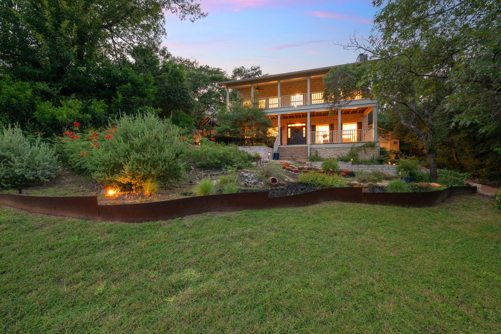 6004 Mt Bonnell Road Austin, TX 78731 - Photo 4 of 24 a view of a big yard in front of a house with large trees