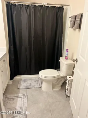 a large bed sitting in a bedroom next to a window