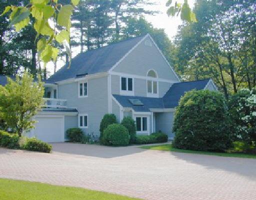 51 Barnes Road, Unit 51 Stamford, CT 06902 - Photo 1 of 1 a front view of a house with a yard and trees