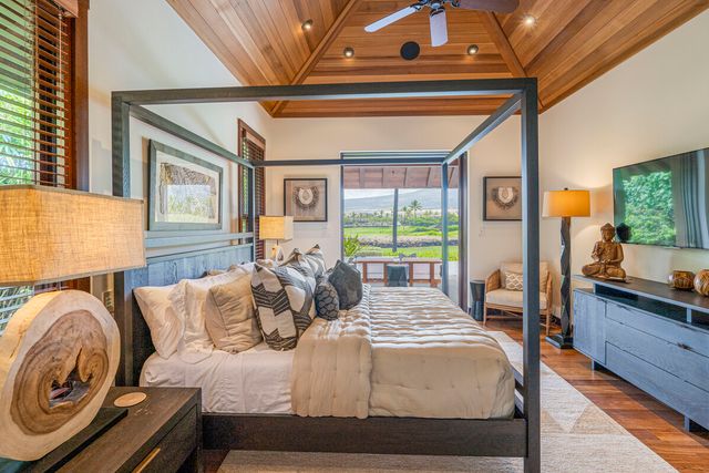 a bedroom with furniture and a large window