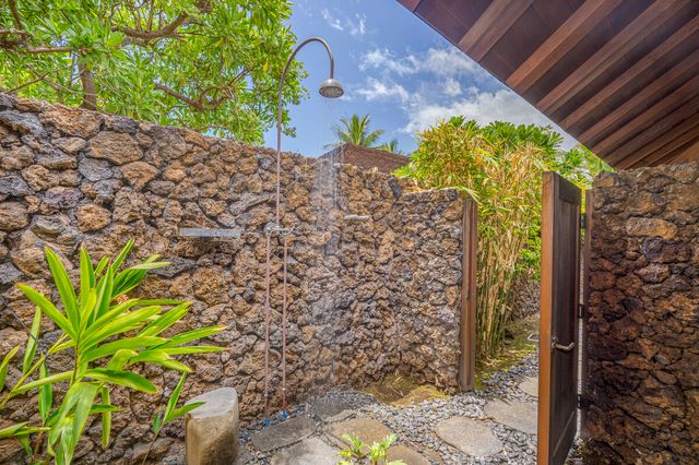 a bedroom with furniture and a large window