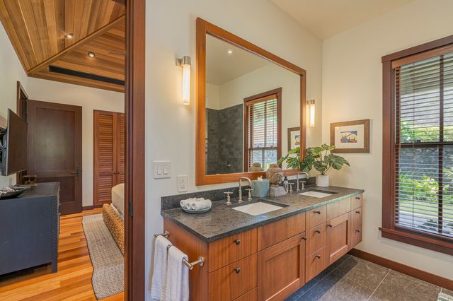 a bedroom with bed and wooden floor