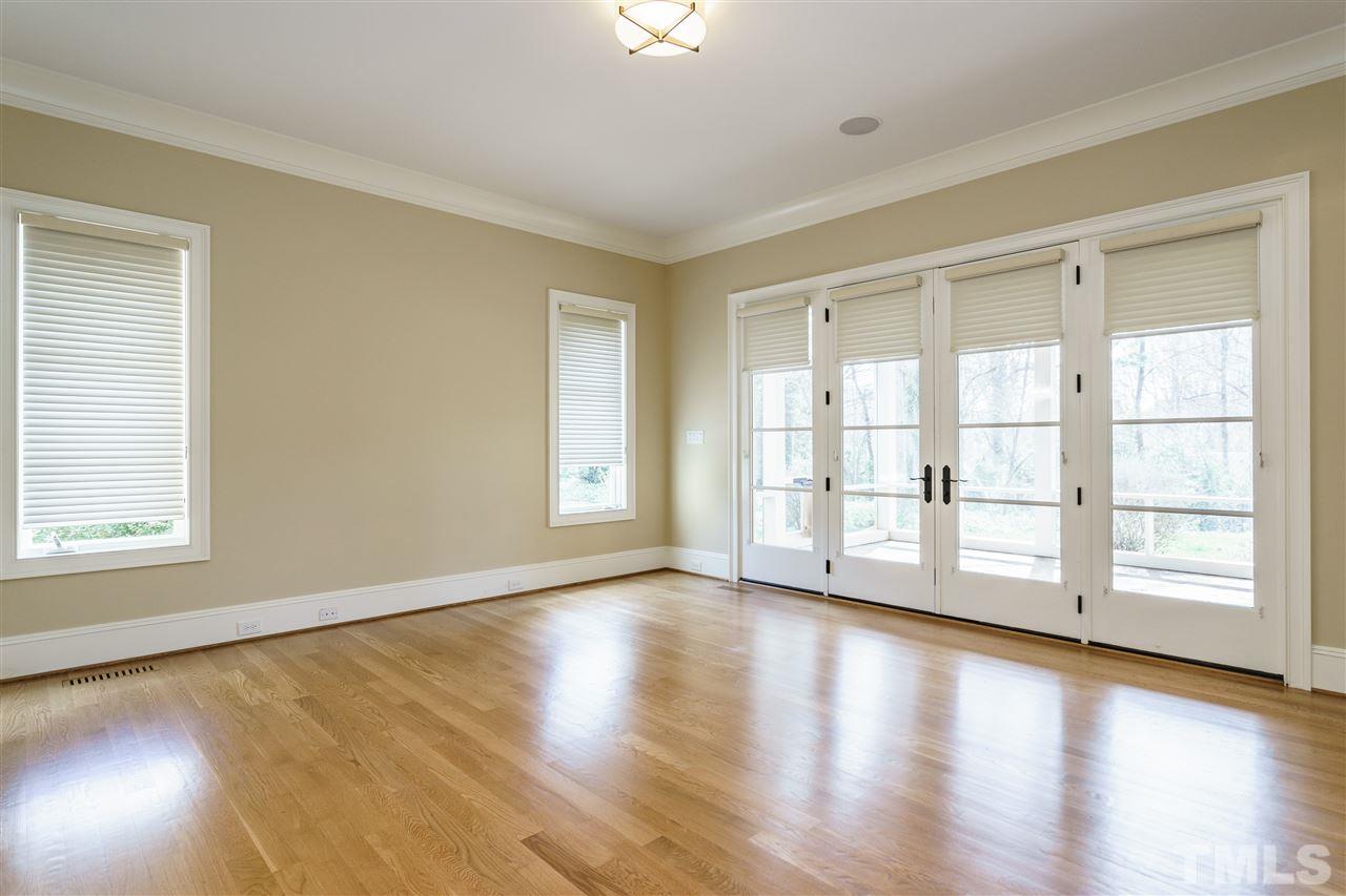2114 Buckingham Road Raleigh, NC 27607 - Photo 15 of 25 a view of an empty room with wooden floor and a window