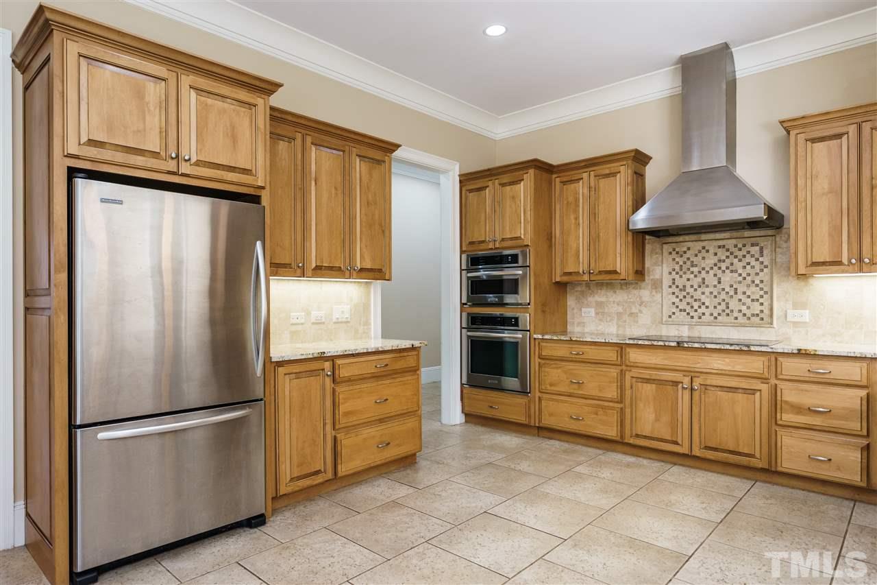 2114 Buckingham Road Raleigh, NC 27607 - Photo 7 of 25 a kitchen with stainless steel appliances a refrigerator sink and cabinets