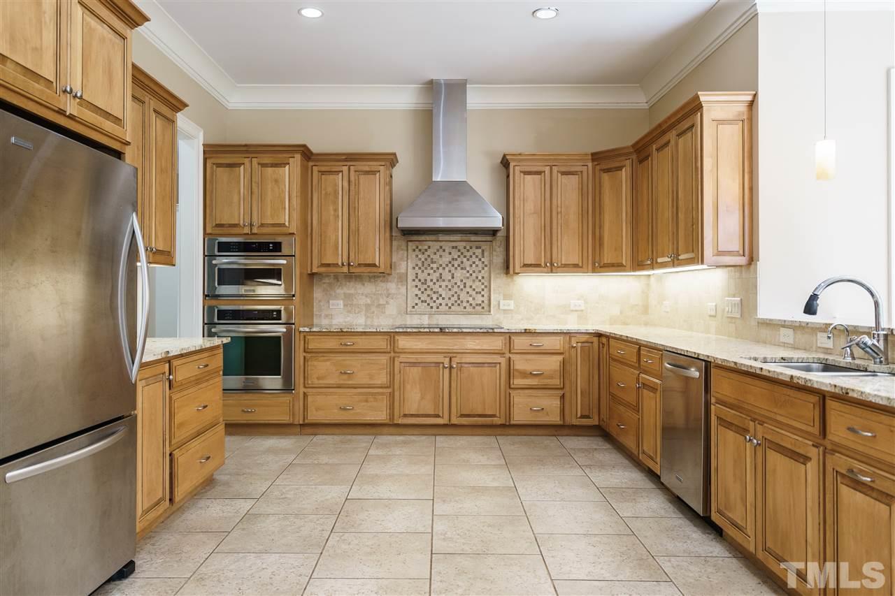 2114 Buckingham Road Raleigh, NC 27607 - Photo 8 of 25 a kitchen with stainless steel appliances granite countertop a refrigerator and a stove top oven