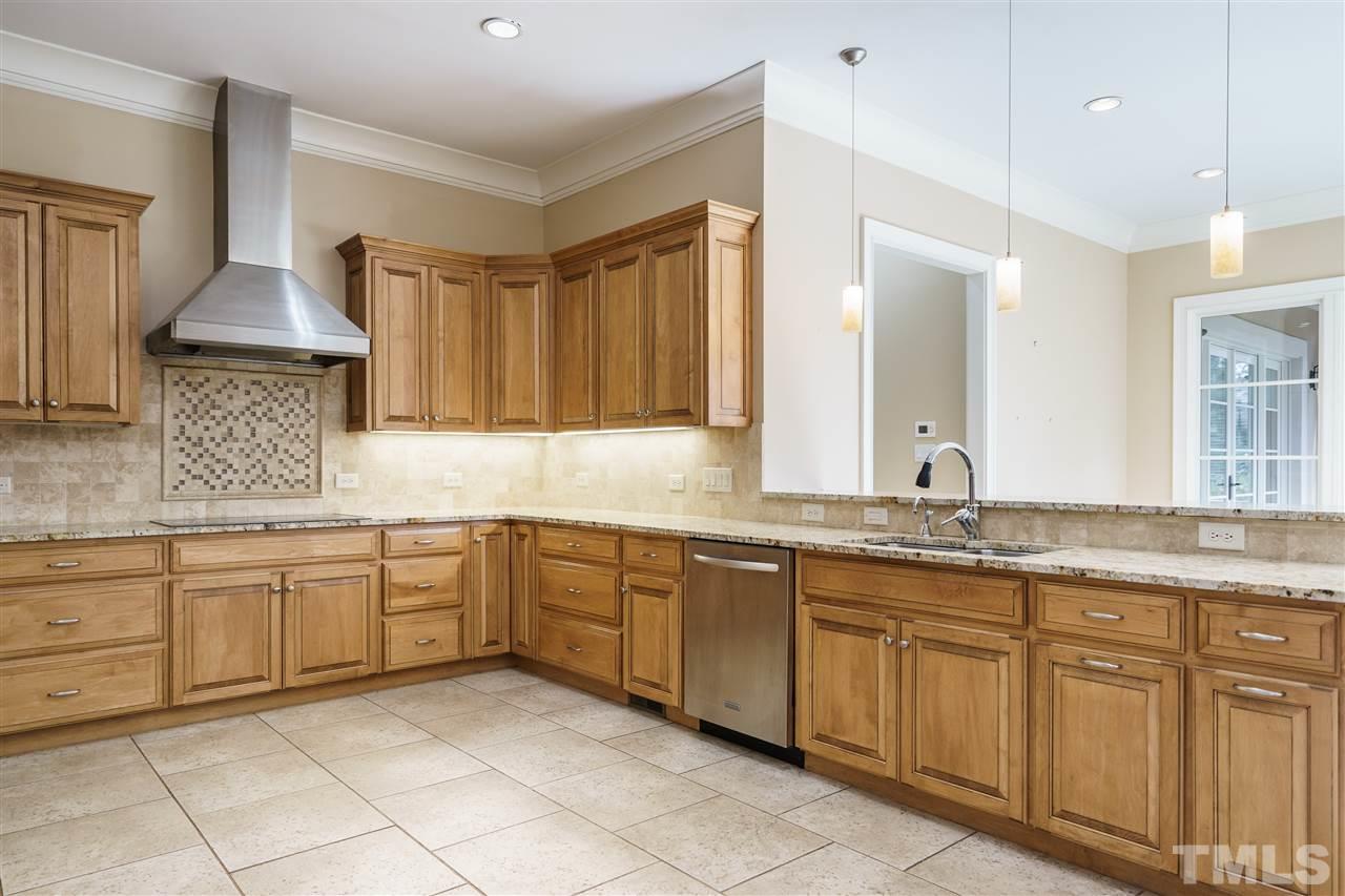 2114 Buckingham Road Raleigh, NC 27607 - Photo 9 of 25 a kitchen with granite countertop sink white cabinets and dishwasher