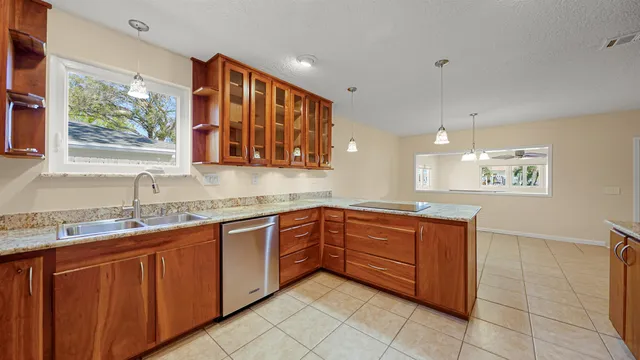 a kitchen with stainless steel appliances granite countertop a refrigerator and a stove top oven