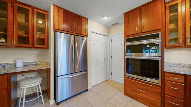 a kitchen with stainless steel appliances granite countertop a refrigerator and a sink