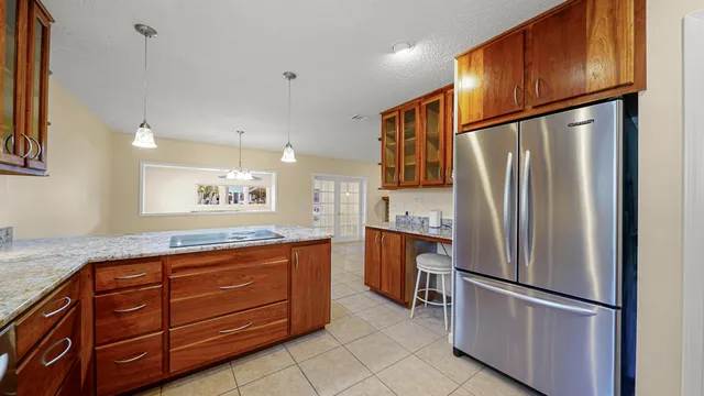 a view of an empty room with window and cabinet