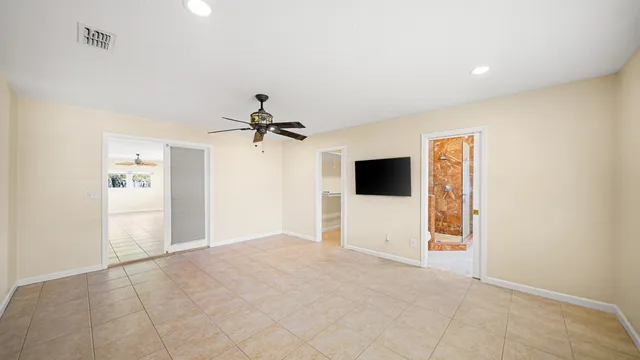a view of a room with window and ceiling fan