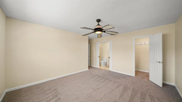 a bathroom with a granite countertop sink a toilet and shower