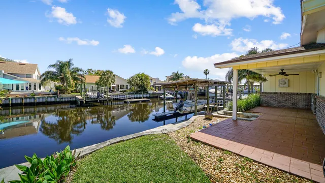 a view of a lake with couches wooden floor and city view