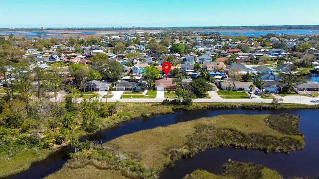an aerial view of a house with a yard
