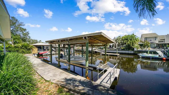 a view of an empty room with wooden floor fireplace and a window