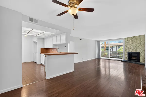 a view of kitchen with granite countertop cabinets with wooden floor