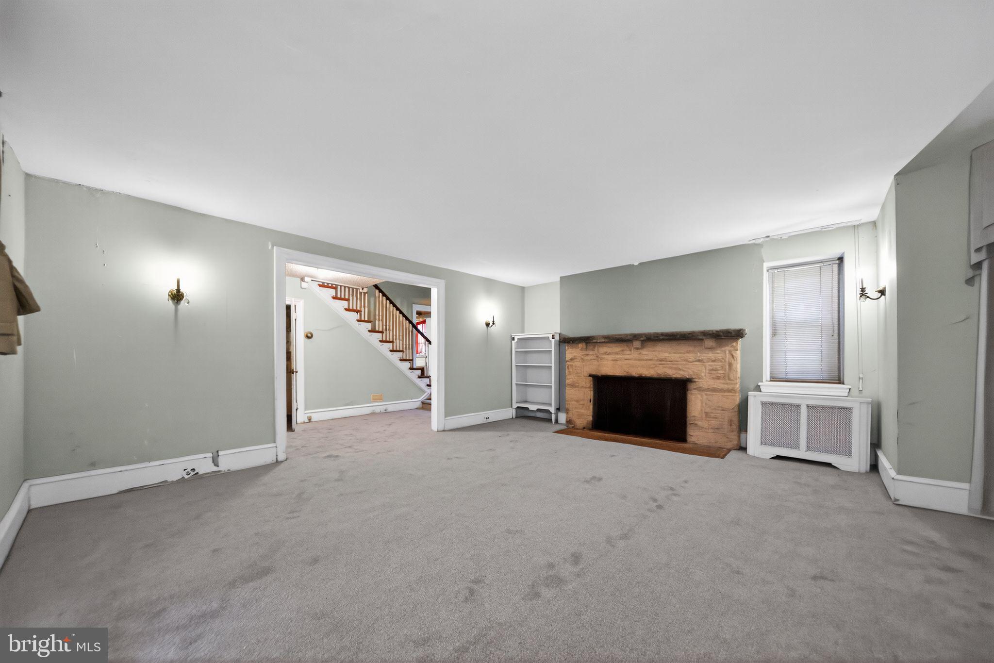 6448 Cherokee Street Philadelphia, PA 19119 - Photo 11 of 33 an empty room with furniture and a fireplace