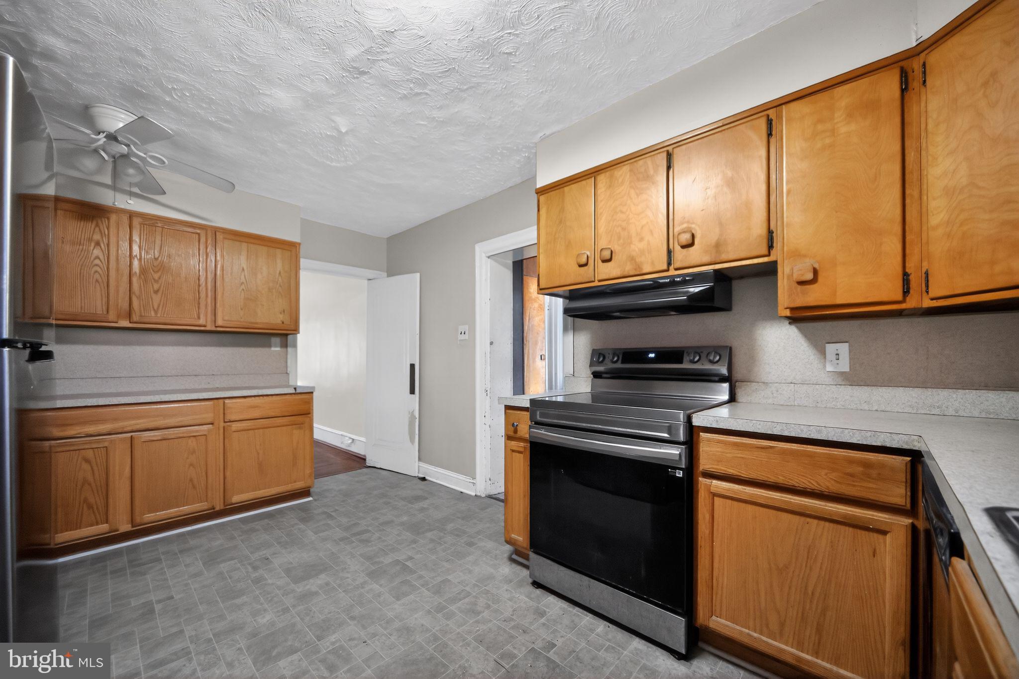 6448 Cherokee Street Philadelphia, PA 19119 - Photo 13 of 33 a kitchen with granite countertop wooden cabinets and stainless steel appliances