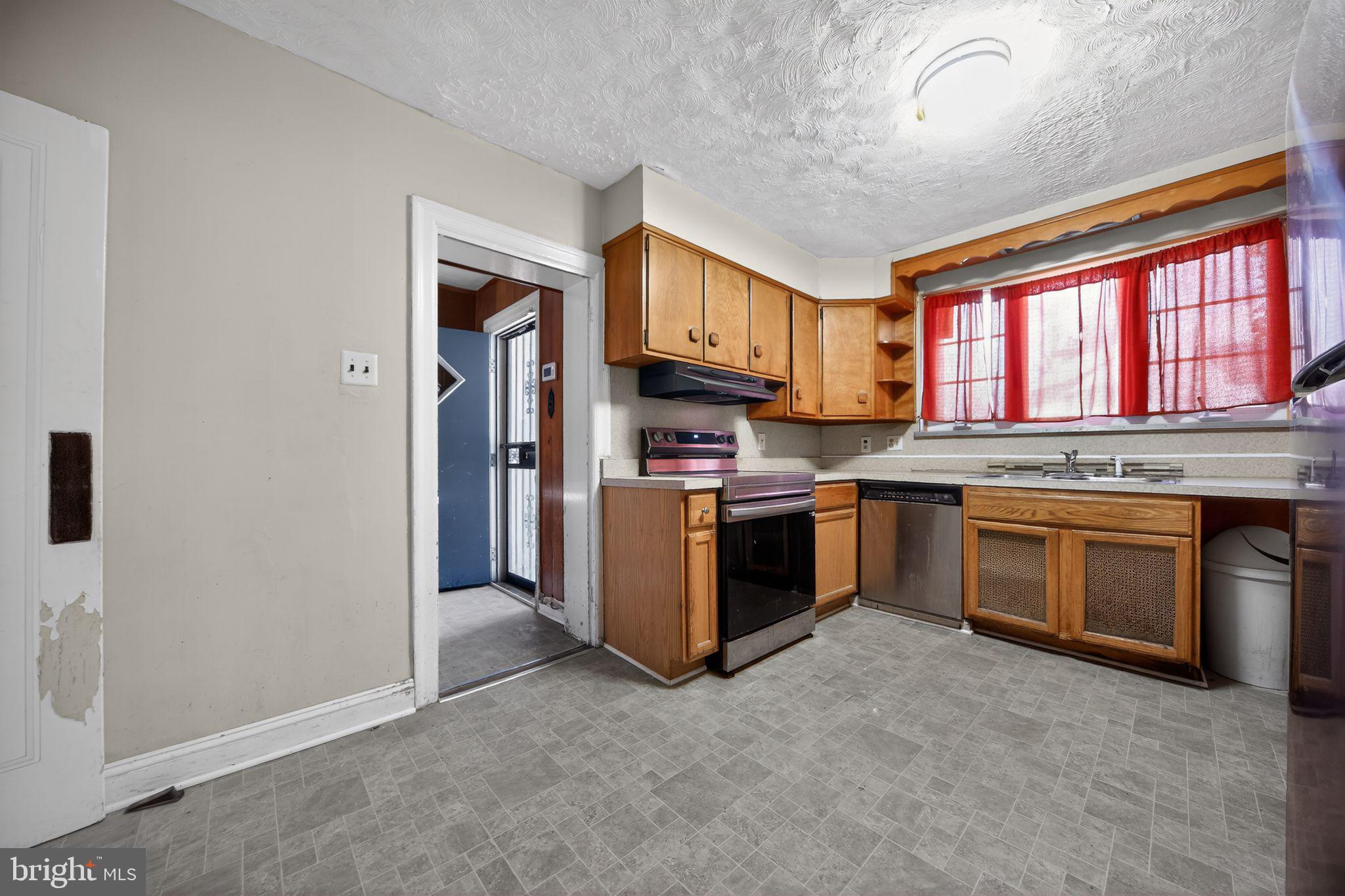 6448 Cherokee Street Philadelphia, PA 19119 - Photo 15 of 33 a kitchen with stainless steel appliances granite countertop a stove a sink and a refrigerator