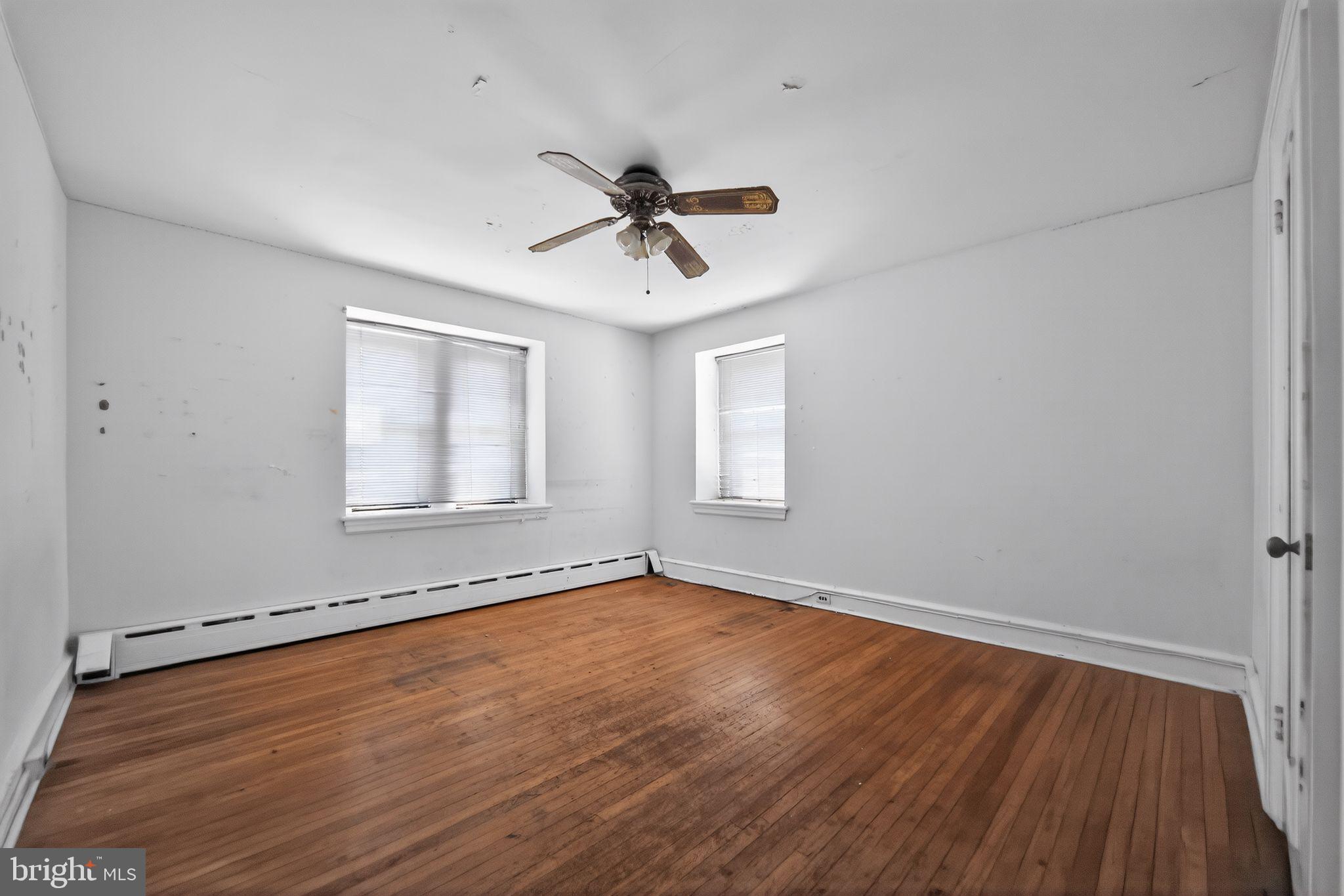6448 Cherokee Street Philadelphia, PA 19119 - Photo 17 of 33 a view of an empty room with a window and wooden floor