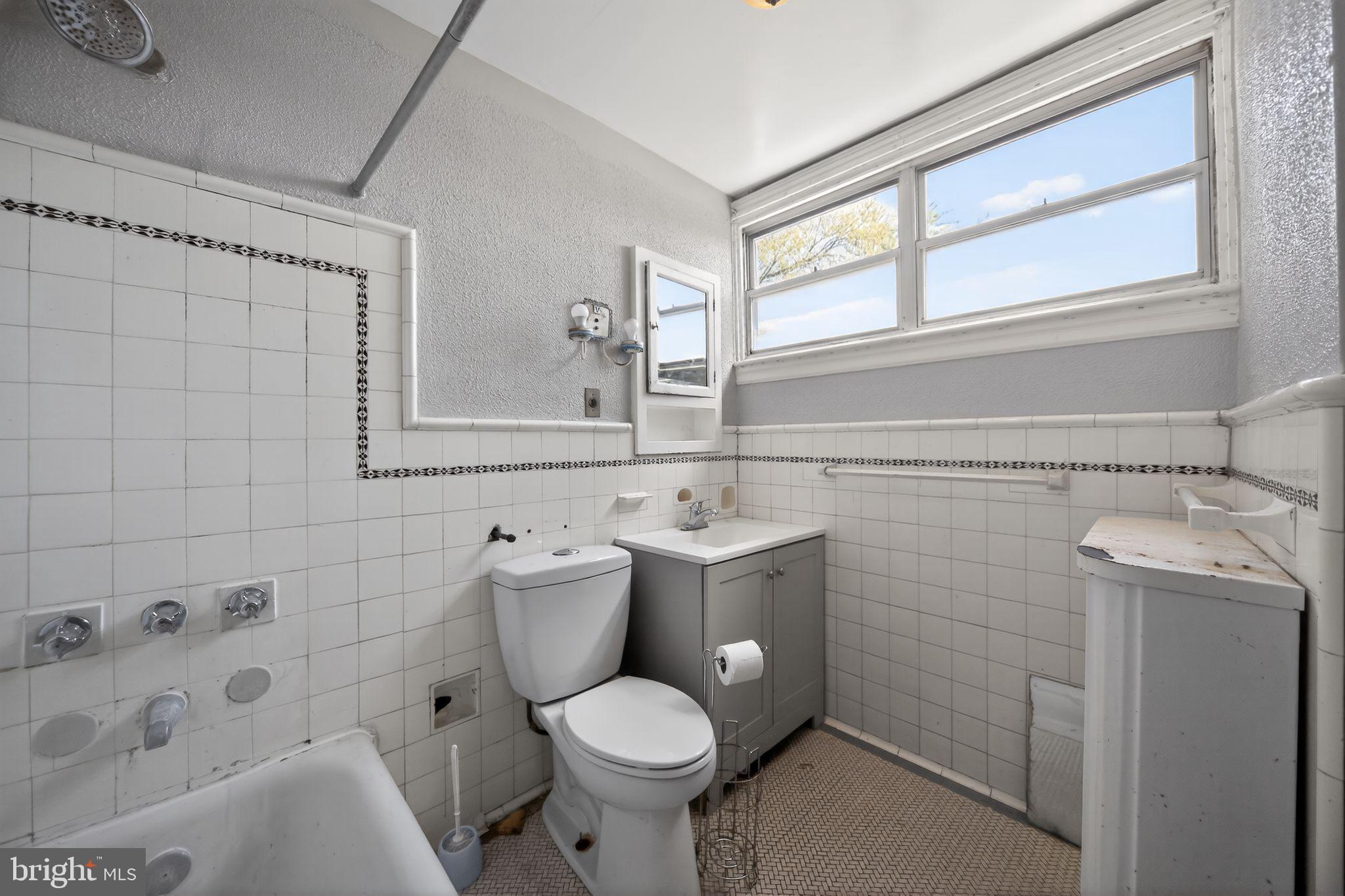 6448 Cherokee Street Philadelphia, PA 19119 - Photo 22 of 33 a bathroom with a toilet sink and mirror