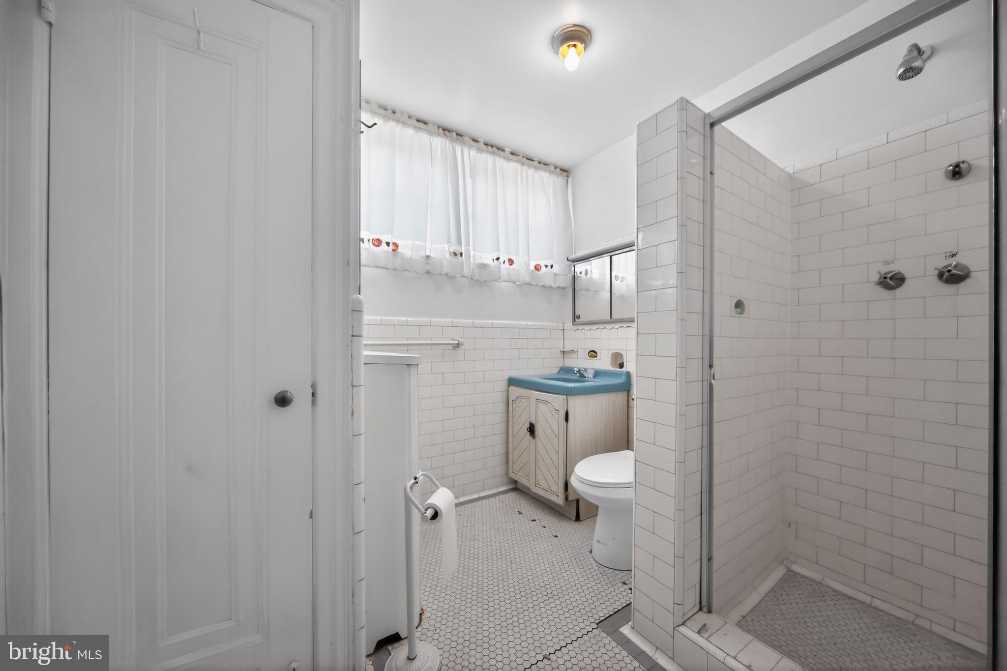 6448 Cherokee Street Philadelphia, PA 19119 - Photo 23 of 33 a bathroom with a granite countertop sink toilet and shower