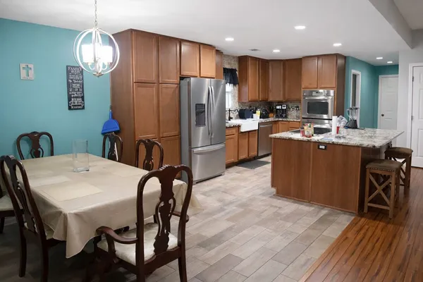 a living room with furniture and kitchen view