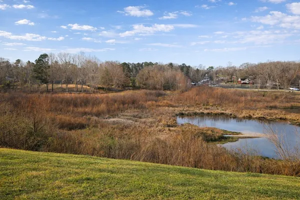 a bedroom with a bed and a large mirror