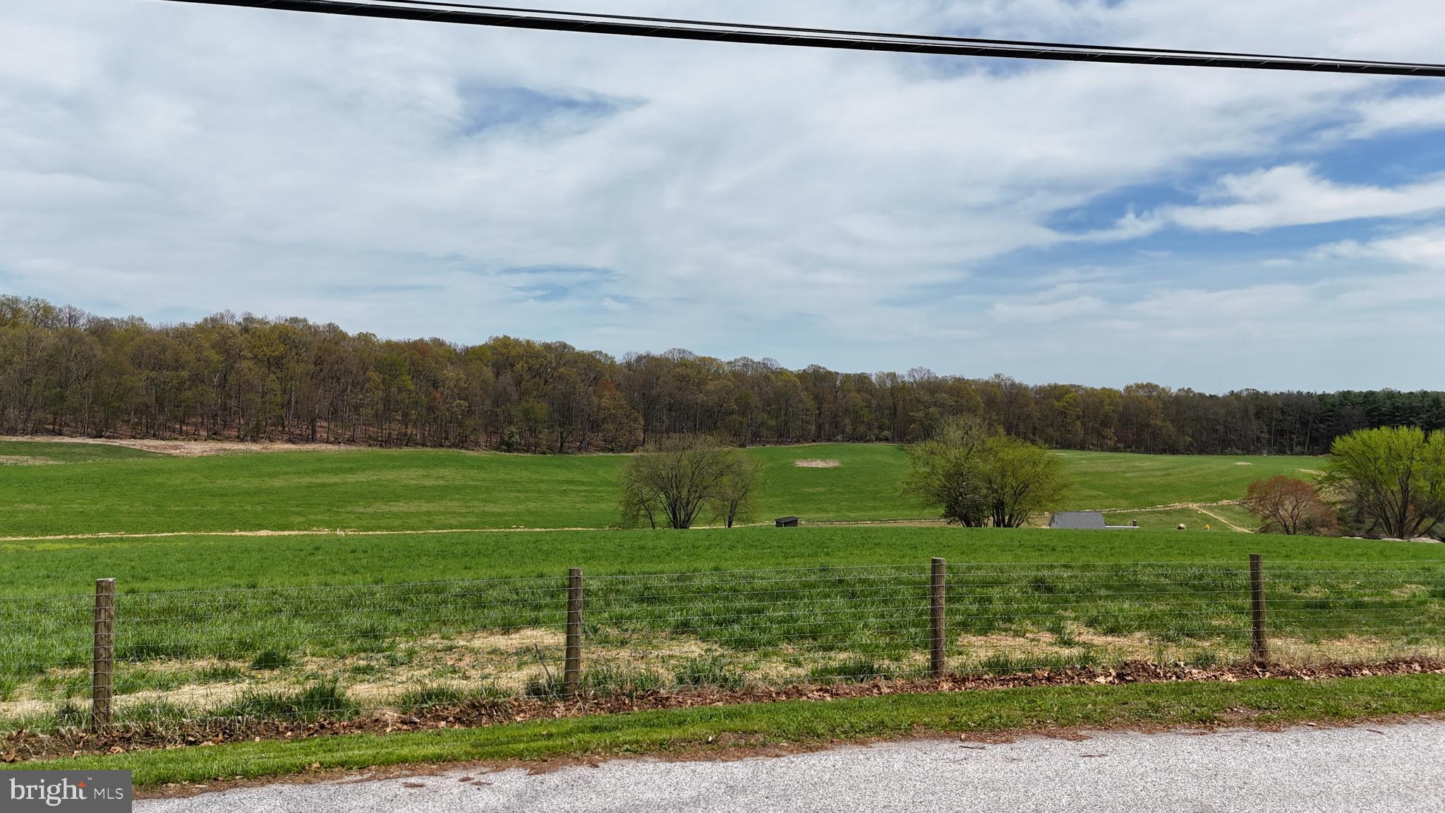 19422 Resh Mill Road Hampstead, MD 21074 - Photo 44 of 55 a view of a lush green field with a view of house
