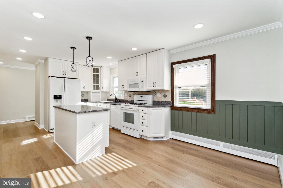 19422 Resh Mill Road Hampstead, MD 21074 - Photo 9 of 55 a kitchen with white cabinets and window