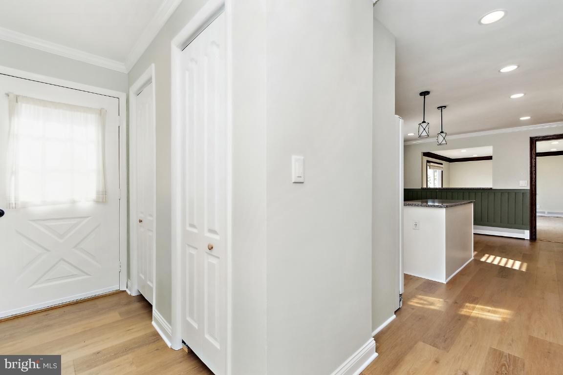 19422 Resh Mill Road Hampstead, MD 21074 - Photo 10 of 55 a view of a hallway with wooden floor and a kitchen