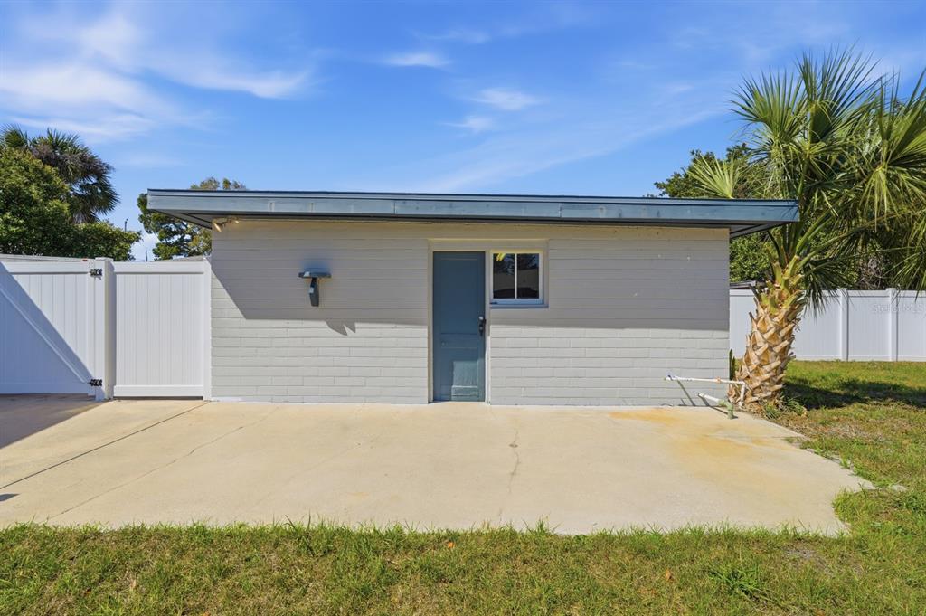 231 North Ridgewood Avenue Ormond Beach, FL 32174 - Photo 39 of 52 a front view of a house with a yard and garage